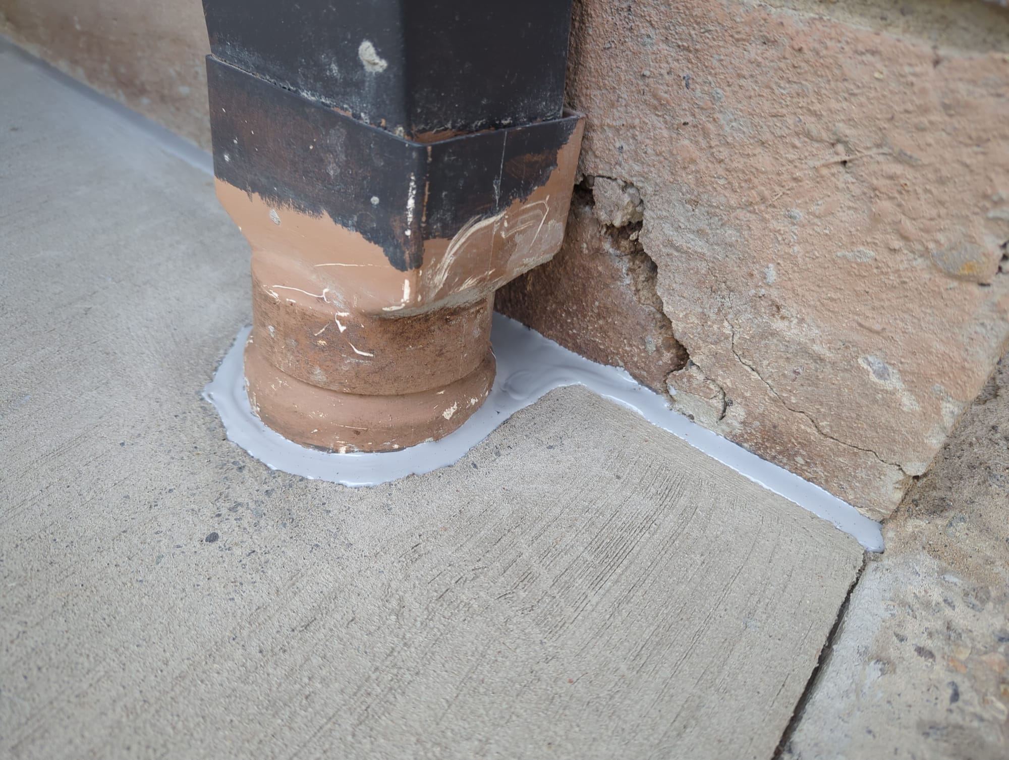 concrete pathway and isolation joint sealant plus downpipe