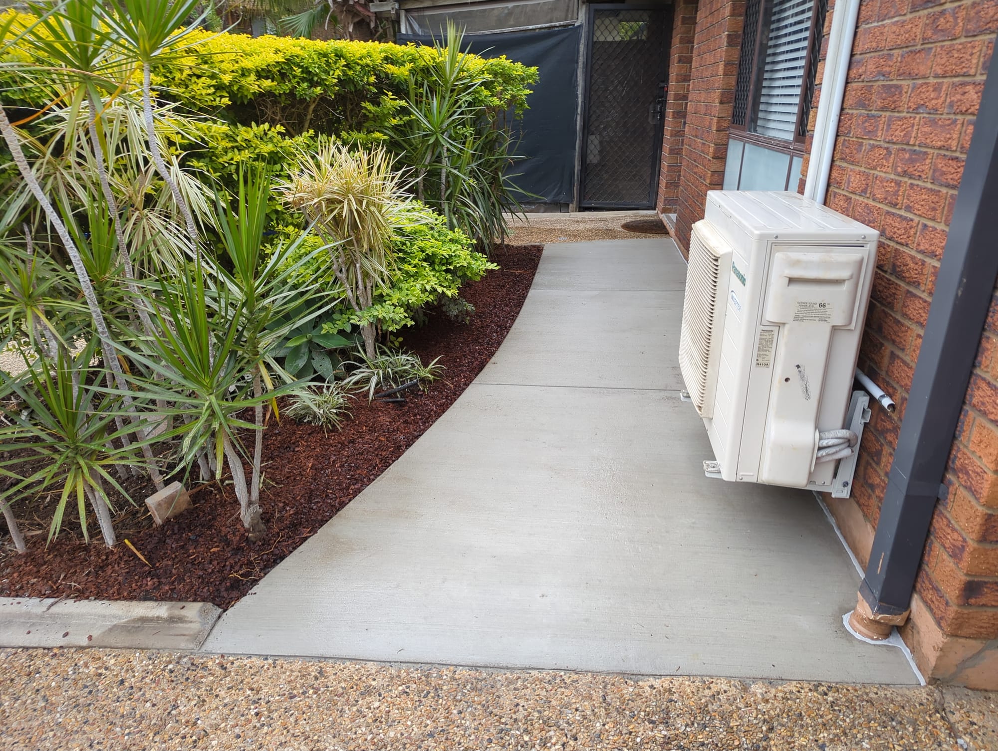 garden bed and concrete pathway