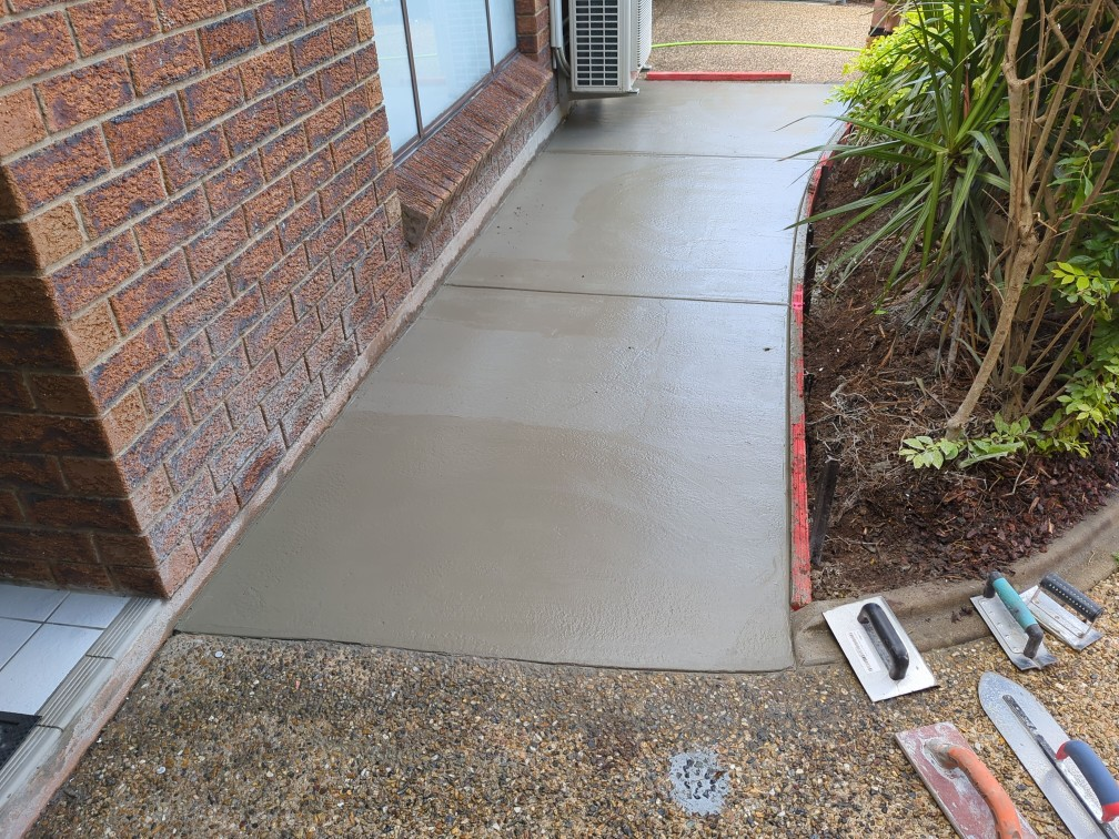 concrete hand finishing tools and wet concrete pathway post pour