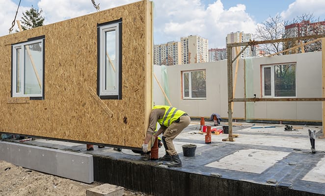 worker placing a modular wall