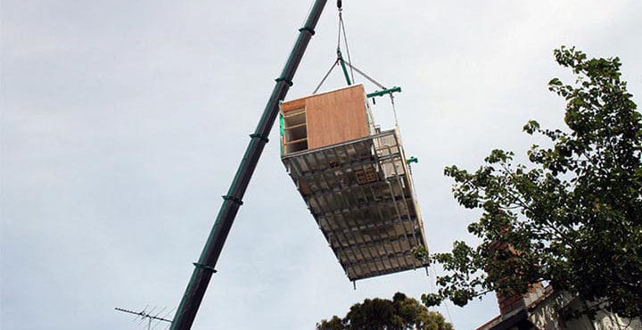 crane lifts a house module