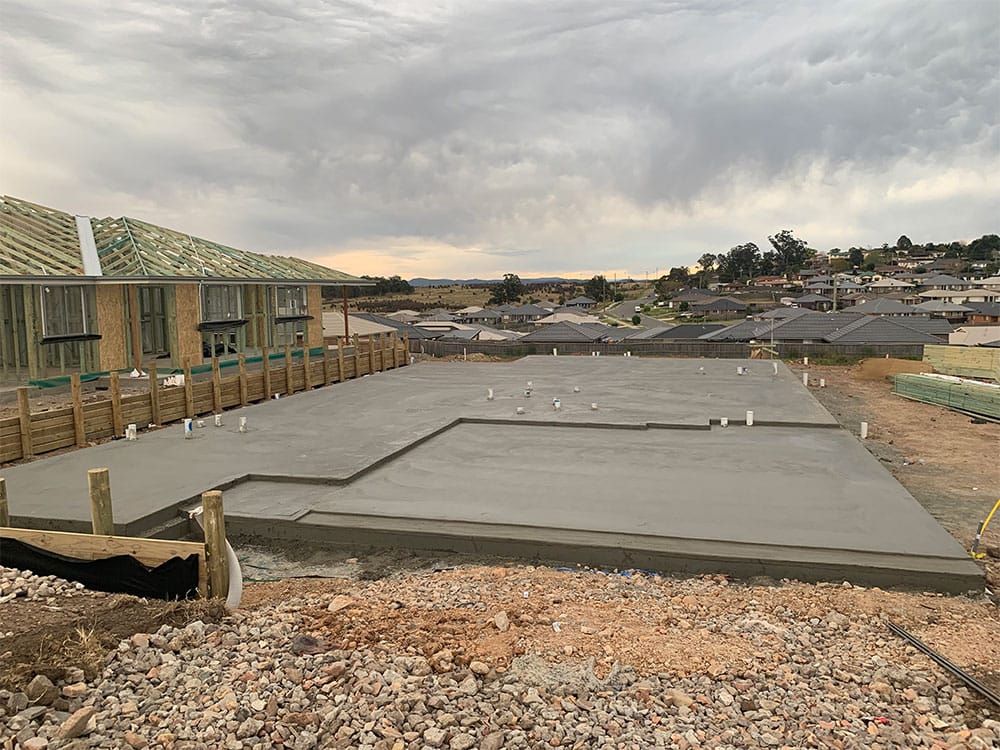 Freshly poured (green) concrete slab, new house construction.