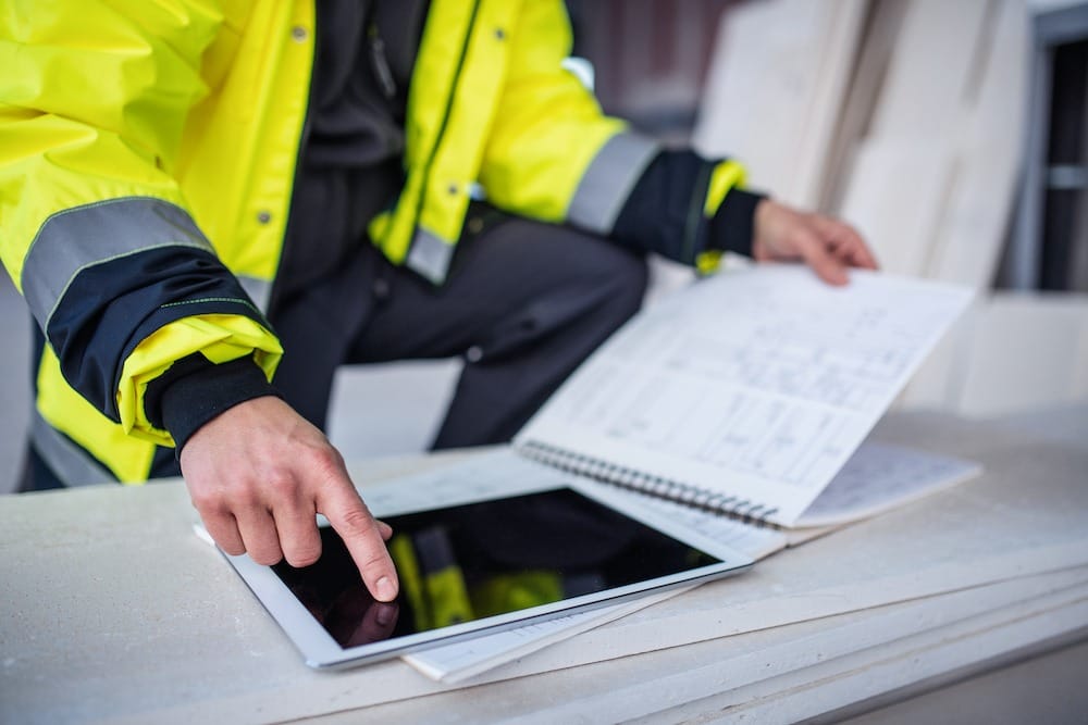 a man pointing to an ipad